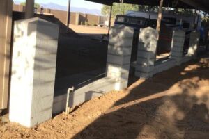 A concrete wall with cement blocks on the side of it.