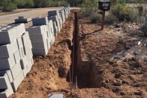 A trench is being dug for the construction of a fence.