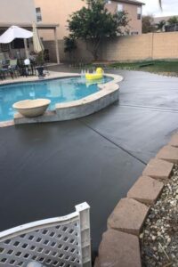 A pool with a concrete slab around it