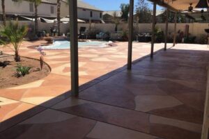 A view of an outside area with a pool and patio.