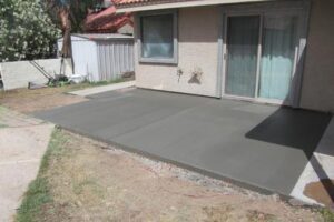 A concrete patio with no grass in the yard.