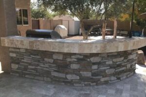 A stone wall with a tree in the middle of it