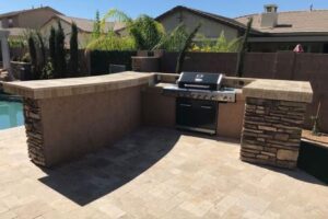 A bbq grill sitting in the middle of an outdoor patio.