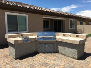 A bbq grill sitting in the middle of an outdoor patio.