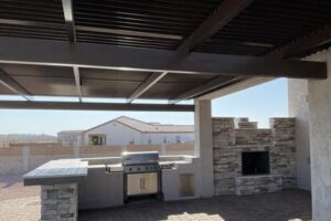 A grill sitting under an awning on top of a patio.