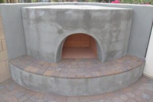 A brick fire pit with an open door.