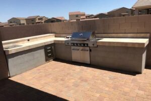 A bbq grill sitting on top of a brick patio.