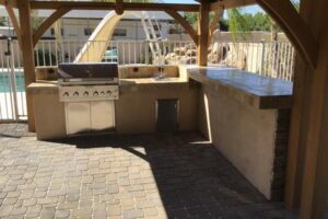 A large outdoor kitchen with an oven and grill.