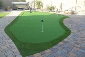 A golf course with artificial grass and putting green.