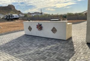 A white concrete bench sitting on top of a brick road.