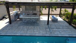 A pool with an outdoor kitchen and bbq