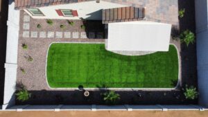 A green lawn with a white awning and patio.