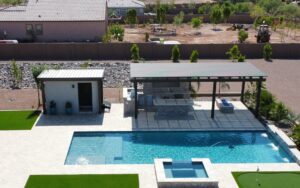 A pool with an outdoor kitchen and swimming pool.