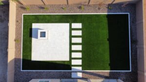 A white tile walkway and green grass