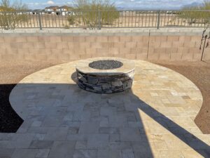 A fire pit sitting on top of a patio.