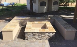 A fire pit sitting on top of a brick patio.