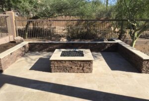 A fire pit sitting in the middle of a patio.