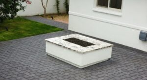 A white box sitting on top of a brick floor.