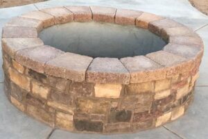 A brick fire pit with a stone surround.