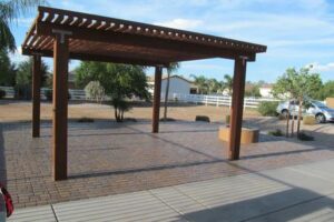 A wooden pergola sitting in the middle of an outdoor area.