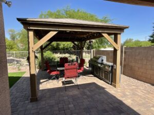 A patio with an outdoor grill and bbq.