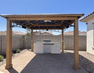 A covered outdoor kitchen with an oven and grill.