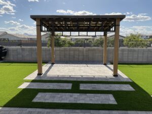 A large wooden structure with grass in the middle of it.