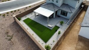 A patio with grass and concrete in the middle of it