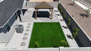 A backyard with a gazebo and a lawn.