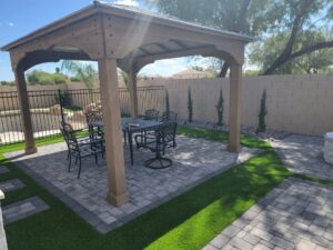 A patio with an umbrella and table set up.