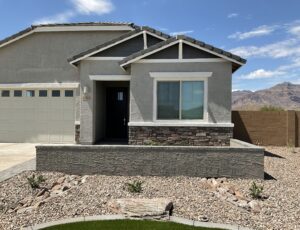 A house with a driveway and lawn in front of it.